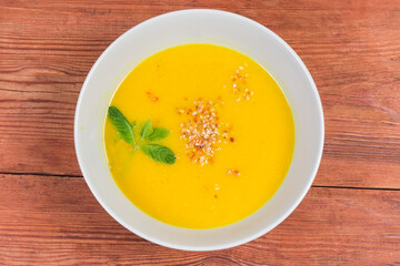 Top view of lentil pumpkin soup puree on rustic table