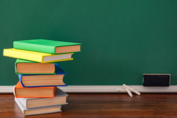 Stack of books on table in classroom