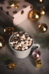 Mug for mockup near christmas tree and gift boxes
