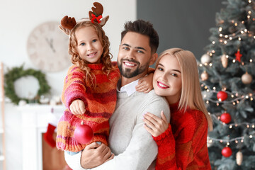 Young family at home on Christmas eve