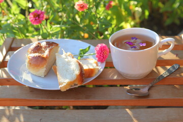 Bun and tea in a cup for breakfast.