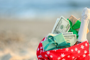 Santa Claus bag with gifts on beach, closeup