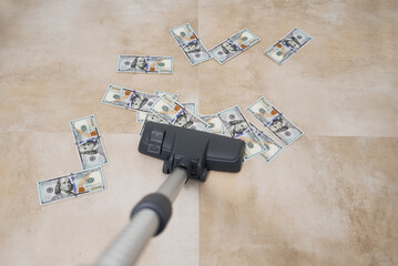 Vacuum cleaner suck usd dollar banknotes. Launder money concept