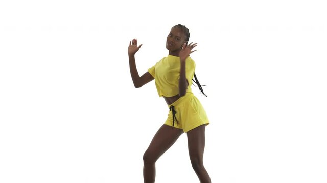 African woman dancing in afro style. Dancer doing swing steps, little bounces and vigorously swaying. Isolated on white background.