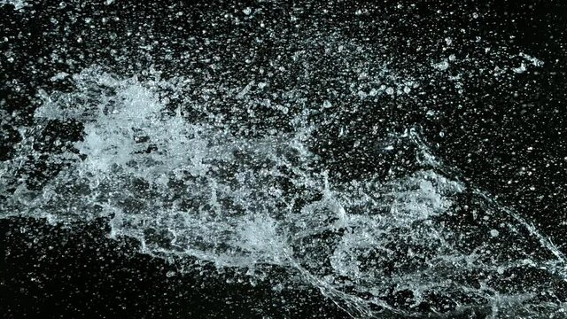 Water splashing on black background, super slow motion. Filmed on high speed cinema camera, 1000 fps.