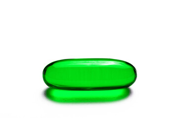 Green single capsule isolated on white. Medicine healthcare background. Drugs dose in group. Painkiller pill. Pharmacy virus cure. Empty copy space tablet backdrop.