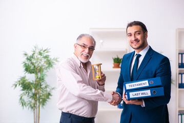 Young male lawyer and old man in testament and time management c