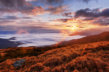 Sunrise in the mountains with dramatic clouds