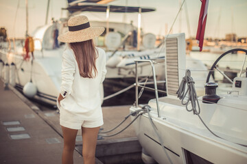 .Young woman on vacation walking in harbor