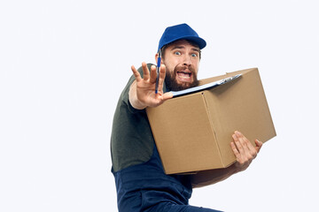 Working male courier with box in hand documents delivery service light background