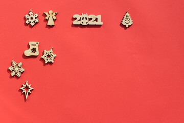 2021 and wooden Christmas toys on a red background. Flat lay, copy space. Christmas card