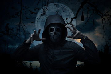 Fototapeta na wymiar Human skull in jacket standing over cross, church, crow, bat, birds, dead tree, full moon and sunset sky, Halloween mystery concept