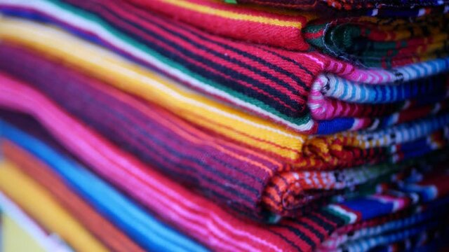 Colorful mexican wool serape blankets texture. Woven ornamental vivid textile with authentic latin american pattern. Striped multi colored fabric for poncho and sombrero. Hispanic indigenous style.