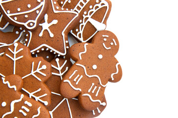 Tasty homemade Christmas gingerbread cookie of various shapes with sugar glaze on white background with copy space. Close up