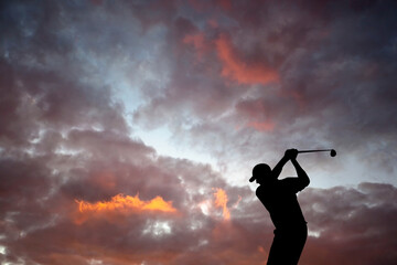 Fototapeta na wymiar Golfer playing golf during sunset at competition event