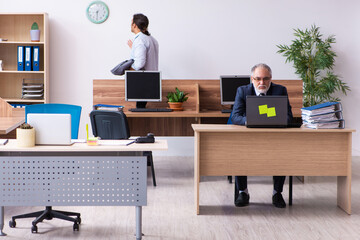 Old boss and his male secretary employee in time management conc