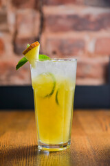 Delicious melon cocktail served in a glass on a rustic wooden table. Seasonal summer beverage, tasty alcohol drink.