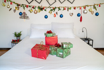 Authentic Chrismas presents on top of bed with suspend decoration.