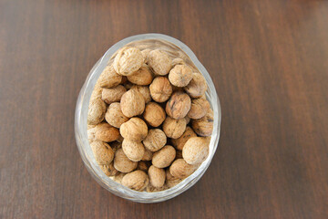 Healthy walnut bowl isolated on wooden table.