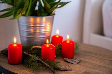 Obraz na płótnie Canvas Bedside table with authentic Chrismas decoration and lit candles.