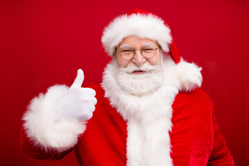 Photo of retired grandpa grey beard raise thumb-up show approval your newyear preparaion home decor x-mas costume white gloves coat spectacles headwear isolated red color background