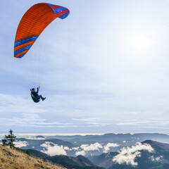 Naklejka na ściany i meble Paraglider above the clouds along the Oregon Coast Range.
