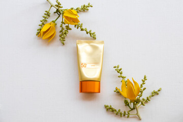 sunscreen spf50 cosmetics beauty makeup healh care for skin face with yellow flowers ylang ylang of...