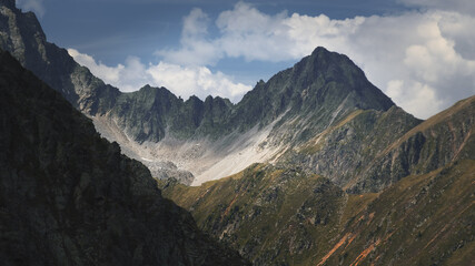The high mountains of the Austrian Alps in Kuhtai during summer season. The sunshine illuminates the beautiful landscape.