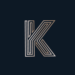 Letter K logo.Typographic icon with overlapping lines.Alphabet initial sign in shiny golden metallic color isolated on dark background.Lettering shape.Beauty, geometric, clean, luxury style character.