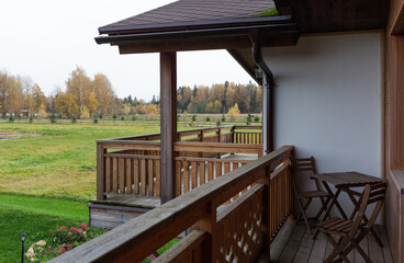 autumn meadow and forest, view from the balcony. Building in the village