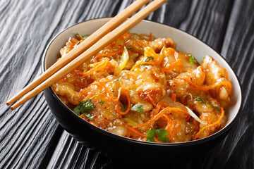 Crispy tasty Guo Bao Rou is a classic dish from Northeast China made with pork in a sweet and sour sauce closeup. Horizontal