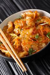 Dongbei Guo Bao Rou Crispy Sweet and Sour Pork closeup on the bowl on the table. vertical