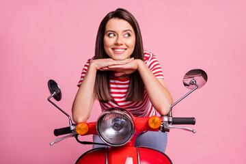 Portrait of her she nice attractive pretty lovely cute pensive minded creative curious cheerful girl sitting on moped thinking enjoying rent isolated over pink pastel color background