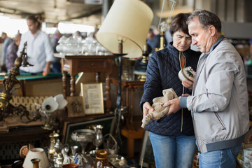 Couple is looking old things at the fleamarket outdoor