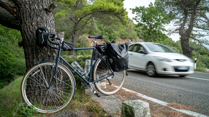 Fototapeta na wymiar Touring bicycle standing near the road with back panniers