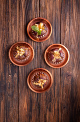 Ripe figs baked with cow's-milk cheese brie and camambert and sprinkled with bread crumbs over on cooper plates over on wooden background. Healthy eating concept. top view. copy space