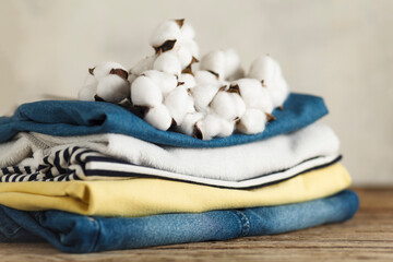 A stack of organic clothing and cotton colors. Eco friendly fabric shop.