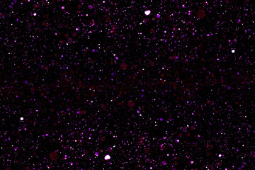 purple bokeh lights defocused on black background. abstract background