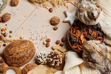 christmas decoration in rustic style and holiday background, still life on wooden backdrop, bread, nuts and other