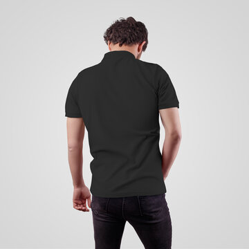 Template of black mens polo on a guy in jeans, back view, isolated on background.