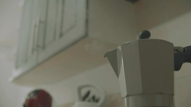 Boiling hot espresso maker, steaming in full force out of the spout. Hot grinder coffee beans flow through the machine with delicious coffee, to make a latte or cappuccino