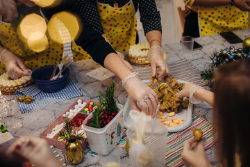 Christmas edible decorations ,for cake decoration. Hands of the pastry chef .Christmas holiday atmosphere.