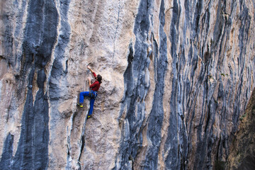 A strong man climbs a rock, Rock climbing in Turkey.