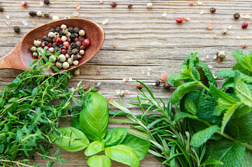 Fresh herbs and spices on wooden background top view