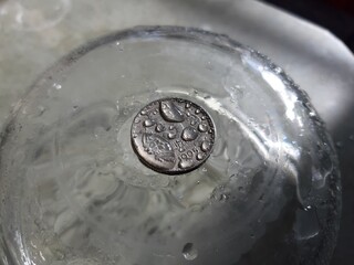 Picture of water droplets over Indian Five Rupee Coin