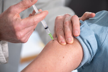 Doctor giving vaccin injection to patient