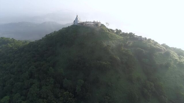 Drone Shot of climbing up towards Dindigad Temple from Bhiwandi City & Fog Covering SKy in Background