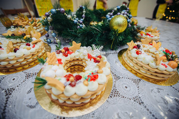 On the table with Christmas decorations are several Christmas cakes in the form of a wreath.Easy to manufacture .