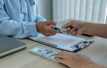A businessman handed bribe money to the officials to sign a business agreement concept about...