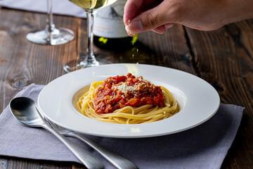 Pasta with meat and tomato sauce on wooden table.
Italian food concept.
